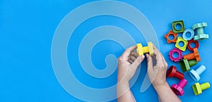 educational constructor for children on blue background, nuts and bolts in the form of geometric shapes. mock up