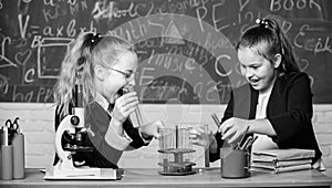 Educational experiment concept. Microscope and test tubes on table. Be careful performing chemical reaction. Basic