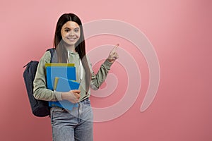 Educational Offer. Smiling Teen Girl With Books Pointing Aside At Copy Space