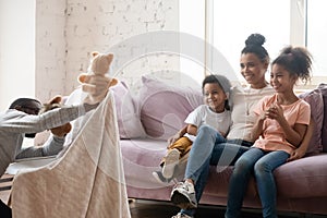 African father hold puppet toys showing theatrical performance for family