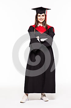 Graduating student girl in an academic gown isolated over white background