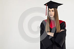 Educational theme: graduating student girl in an academic gown isolated over white background