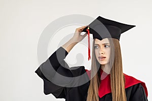 Educational theme: graduating student girl in an academic gown isolated over white background