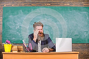 Educator bearded man yawning face tired at work. Educators more stressed at work than average people. Exhausting work in