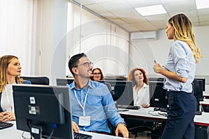 Educator and students in programming school