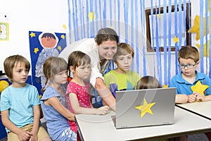 Educator Surrounded by Kids at Kindergarten