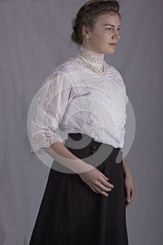 Edwardian woman in white blouse and black skirt