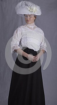 Edwardian woman in white blouse and black skirt