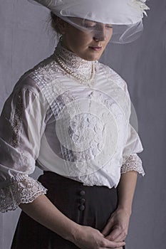 Edwardian woman in white blouse and black skirt