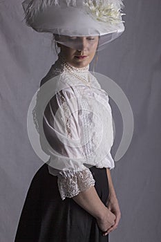 Edwardian woman in white blouse and black skirt