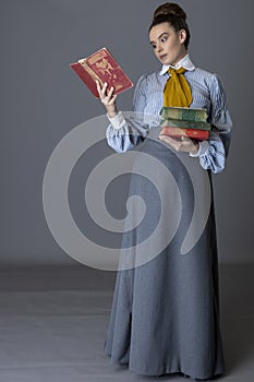 An Edwardian working class woman wearing a striped cotton blouse, mustard yellow cravat, and a grey walking skirt