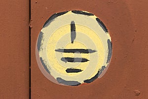 Eectric ground hazard warning sign symbol on a painted metal surface