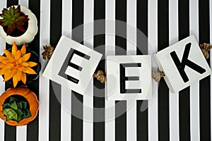 Eek Halloween phrase letters on fun black and white stripe backdrop photo