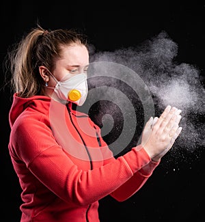Een girl in protective sterile medical mask on her face posing over black background