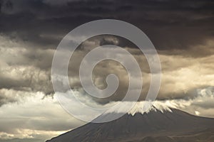 Eerie scenery of Biblical Mount Ararat with dark clouds above it
