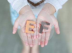 EF Executive Functions sponge text on child hands. Education and development concept