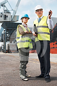Effective communication among co-workers is vital. Two engineers discussing planning on a site while in the shipyard.