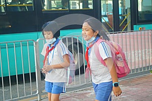 Shenzhen, China: after school in the afternoon, some students take their parents` electric bikes home, while others walk on their