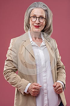 Effective mature woman in beige jacket