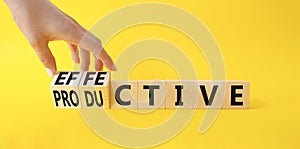 Effective and Productive symbol. Businessman Hand turns a cube and changes the word Productive to Effective. Beautiful yellow