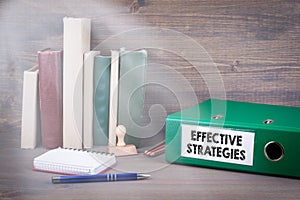 Effective Strategies. Binder on desk in the office. Business backgroundr