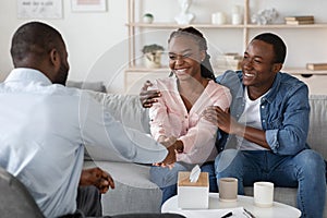 After Effective Therapy. Joyful Black Couple Handshaking With Marital Counselor After Session