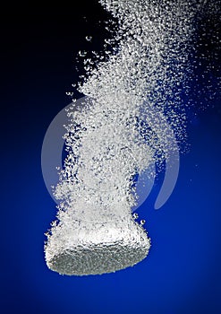 Effervescent tablet in water with bubbles