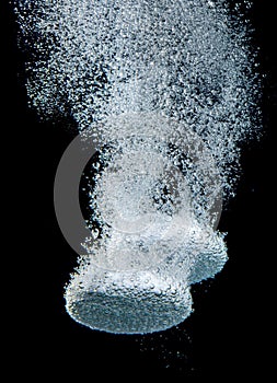 Effervescent tablet in water with bubbles