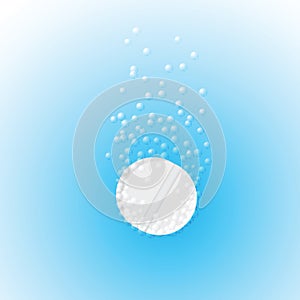 Effervescent tablet in water with bubbles on a blu