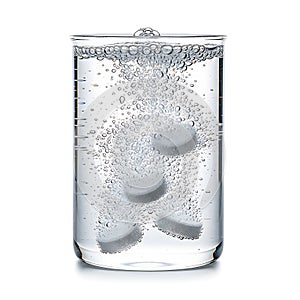 Effervescent tablets dissolving in a glass of water