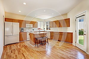 Efficient, compact kitchen design with honey stained kitchen cabinets