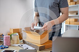 Efficient Home-Based Delivery, Man Packing Items into Post Box for Customer Shipping