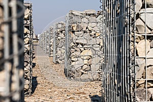 Efficient noise and erosion protection. Gabion retaining wall or fence closeup.