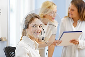 efficient smiling secretary answering phone calls