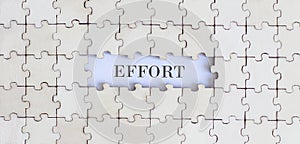 EFFORT .Business concept. White puzzle pieces with different phrases on the white background, top view