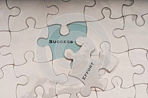 Effort and success wordings on puzzle pieces