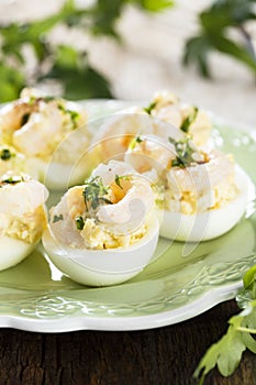 Egg appetizer with herbs and shrimps