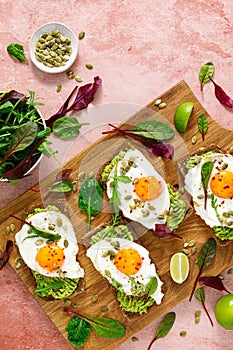 Egg and avocado toast, sandwiches with eggs and fresh greens