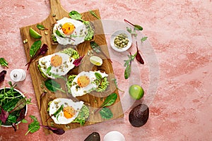 Egg and avocado toast, sandwiches with eggs and fresh greens