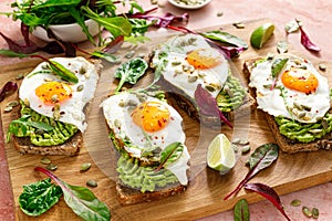 Egg and avocado toast, sandwiches with eggs and fresh greens