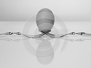Egg balancing on two forks