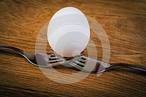 Egg balancing by two forks