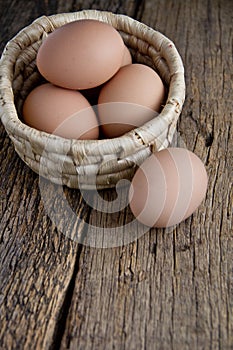 Egg in basket on wood