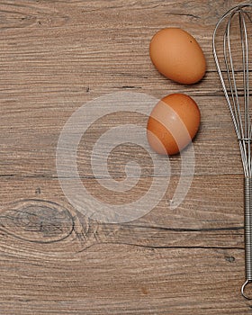 An egg beater, with two eggs
