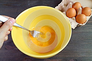 Egg Being Beaten in a Mixing Bowl for the Concept of HOME COOKING photo