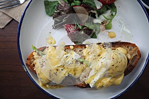 Egg benedict , poached eggs with toast on wooden table , English Breakfast