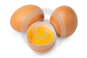 Egg. Brown eggs. Half an egg with yellow yolk. Organic raw non boiled chicken eggs. Brown eggshell.