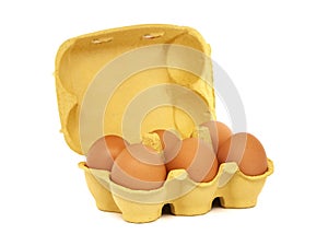 Egg carton with six brown eggs isolated on white background