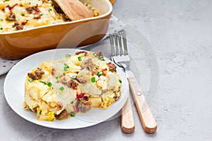 Egg casserole with potatoes, sausage and pepper, in baking dish, copy space