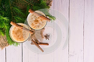 Egg cocktail with cinnamon. Eggnog Ð¾n a white wooden background top view.